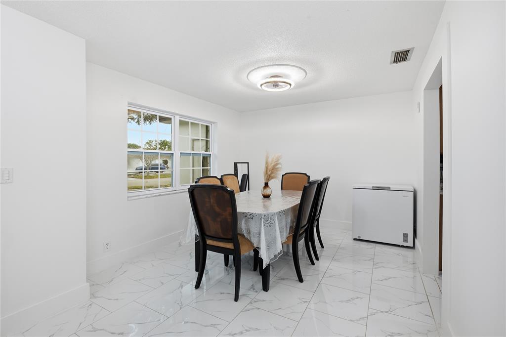 6599 Northwest 1st Street Margate, FL 33063 - Photo 28 of 43 a view of a dining room with furniture