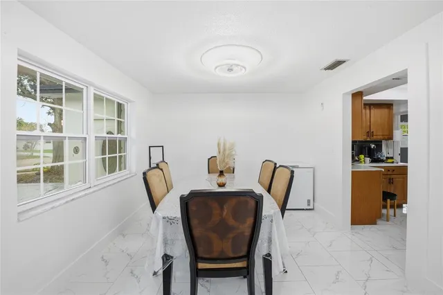 a dining room with furniture and window