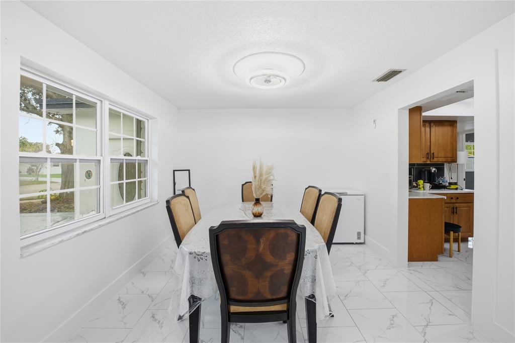 6599 Northwest 1st Street Margate, FL 33063 - Photo 29 of 43 a dining room with furniture and window