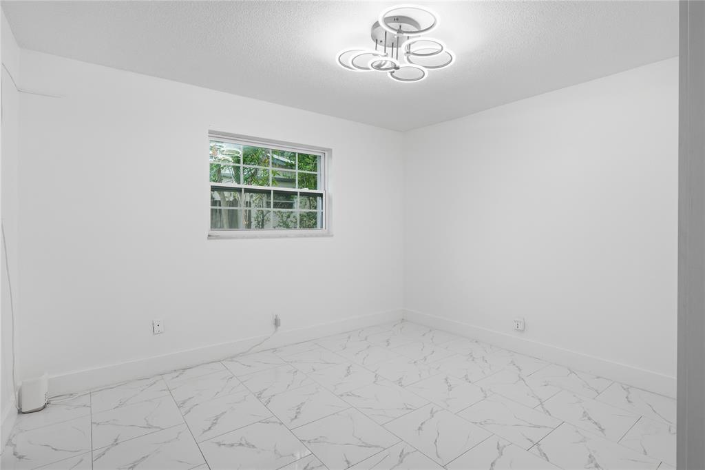 6599 Northwest 1st Street Margate, FL 33063 - Photo 33 of 43 an empty room with a window