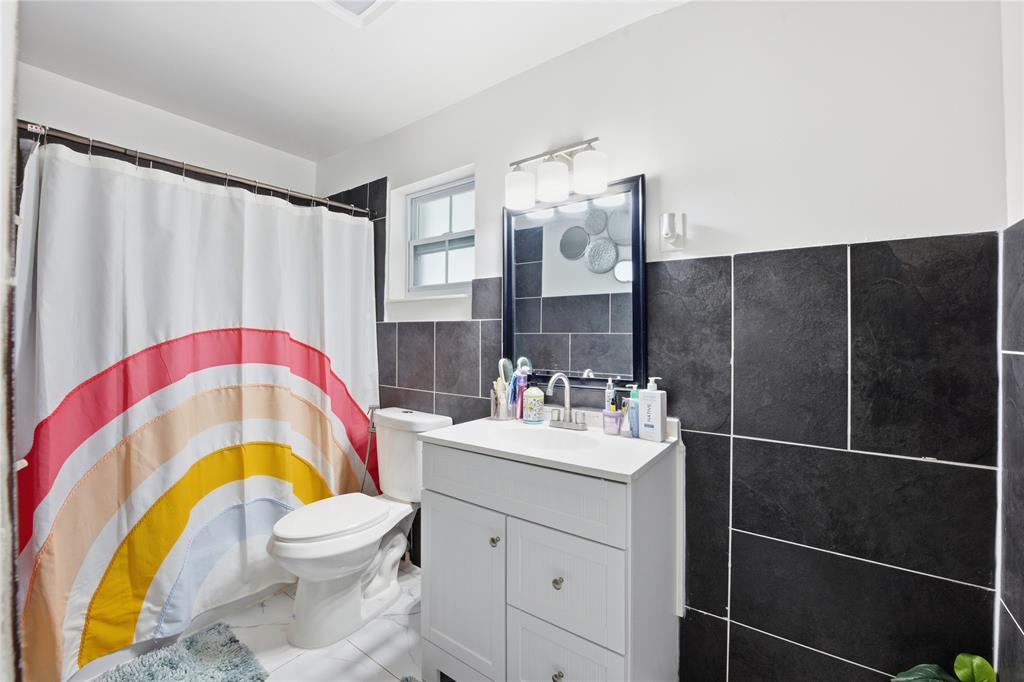 6599 Northwest 1st Street Margate, FL 33063 - Photo 36 of 43 a bathroom with a sink a toilet and shower