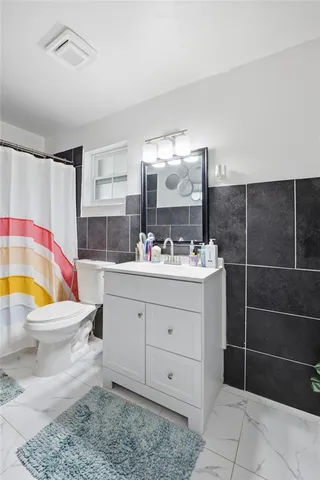 a bathroom with a sink toilet and shower