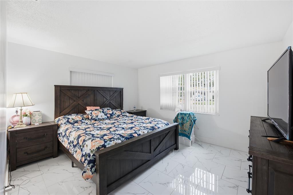 6599 Northwest 1st Street Margate, FL 33063 - Photo 38 of 43 a bedroom with a bed and a window