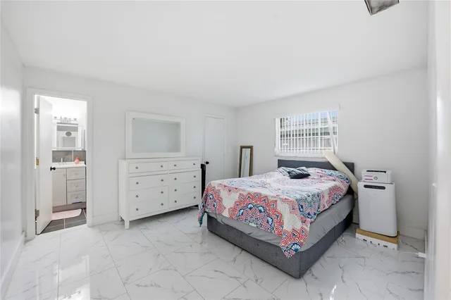 a bedroom with a bed and a dresser