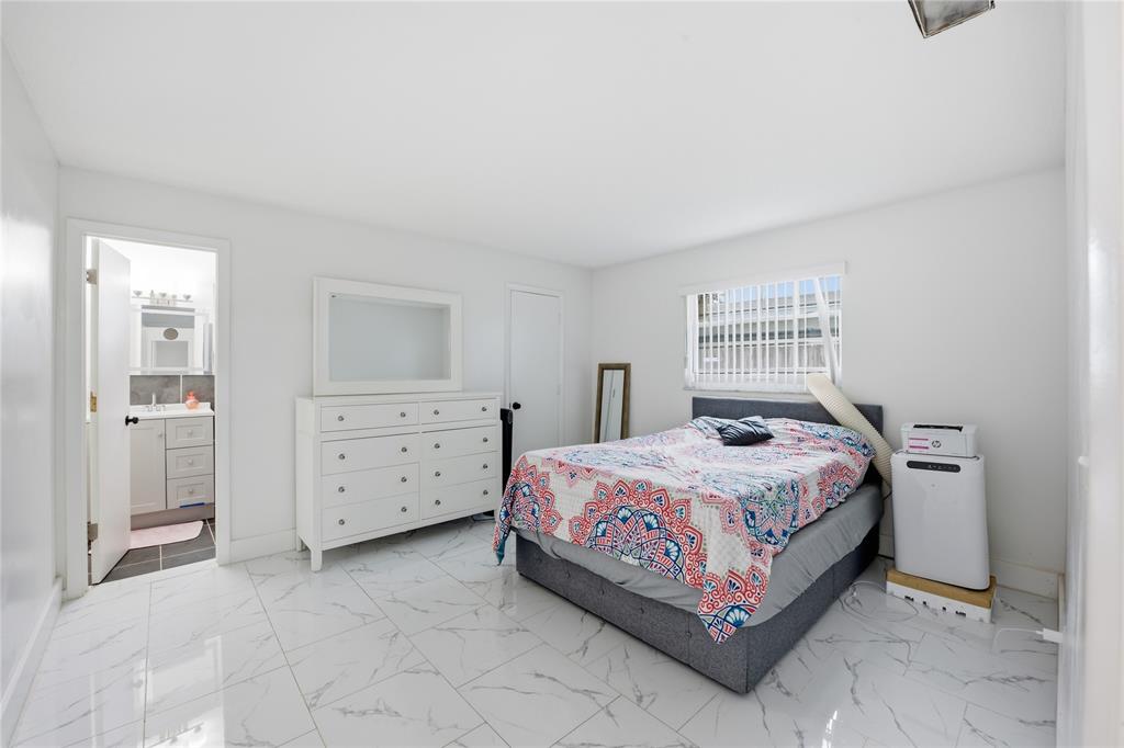 6599 Northwest 1st Street Margate, FL 33063 - Photo 39 of 43 a bedroom with a bed and a dresser