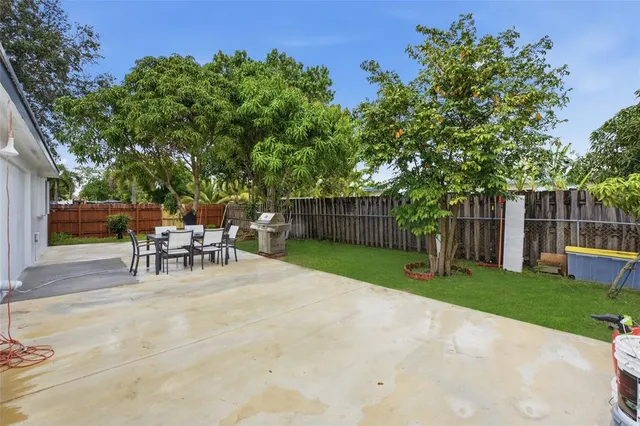 a view of a backyard with a sitting area and a garden
