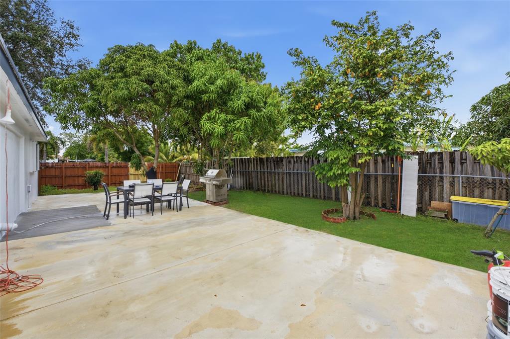 6599 Northwest 1st Street Margate, FL 33063 - Photo 40 of 43 a view of a backyard with a sitting area and a garden