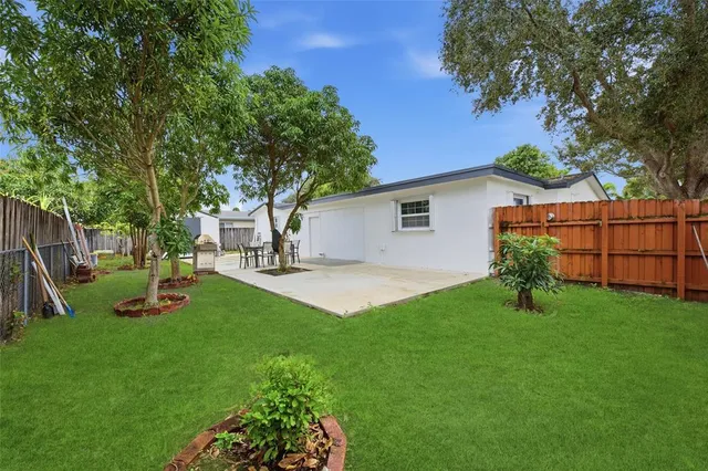 a view of a backyard with large tree