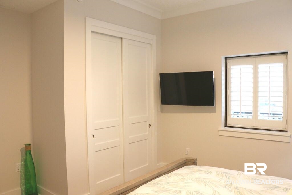 18269 Colony Drive, Unit 803 Fairhope, AL 36532 - Photo 16 of 27 Bedroom with a closet and crown molding