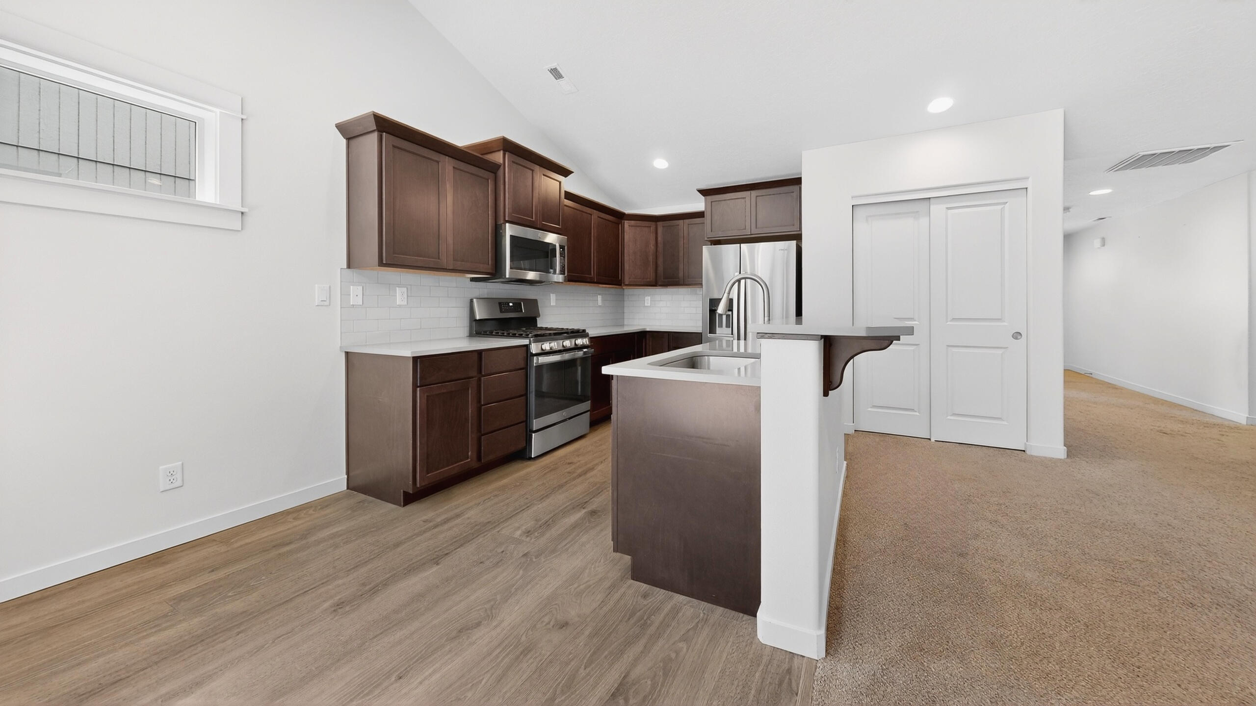 680 McKinney Ranch Road Sisters, OR 97759 - Photo 20 of 41 a kitchen with stainless steel appliances granite countertop a refrigerator a stove top oven a sink and dishwasher with wooden floor