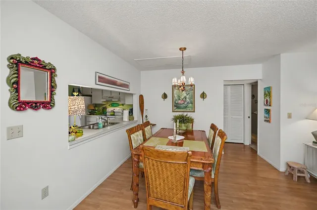 a view of a dining room with furniture a livingroom and chandelier