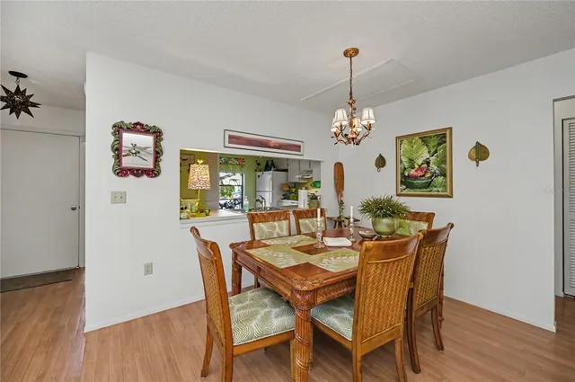 a view of a dining room with furniture a livingroom and chandelier