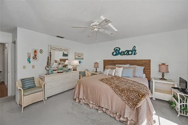 a bedroom with a bed dresser and a window