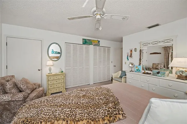 a bathroom with a granite countertop sink a mirror and shower