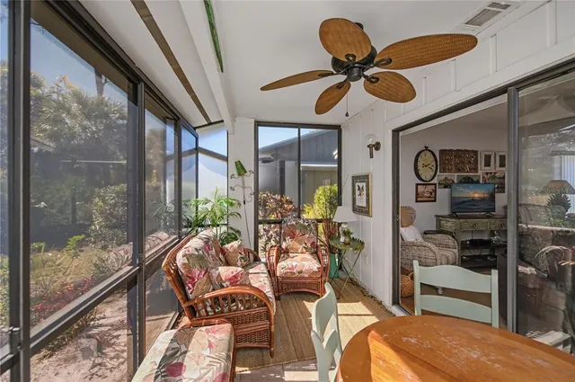 a view of a house with a small yard and floor to ceiling window
