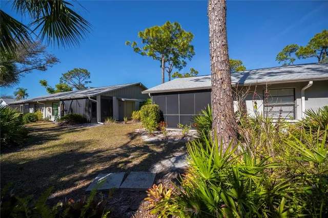 a view of a house with wooden fence next to a road