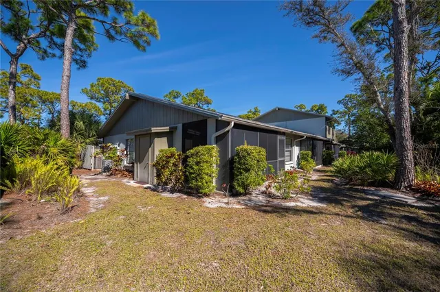 a view of a house with a tree in the background