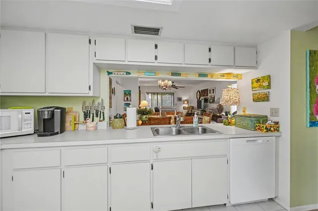 a kitchen with a sink appliances and cabinets