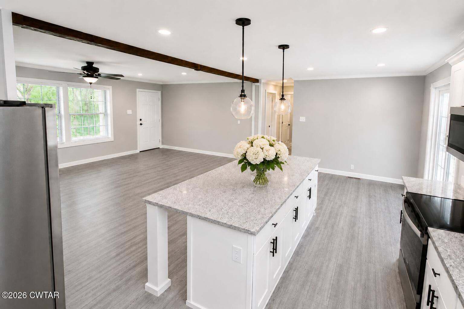 398 Pope Road Lexington, TN 38351 - Photo 7 of 21 a kitchen with a sink a chandelier and wooden floor