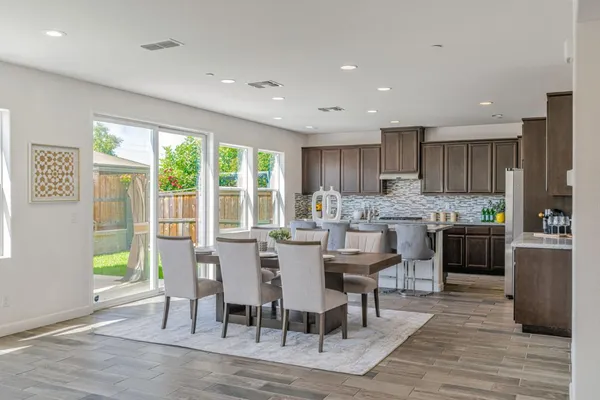a kitchen with refrigerator and cabinets