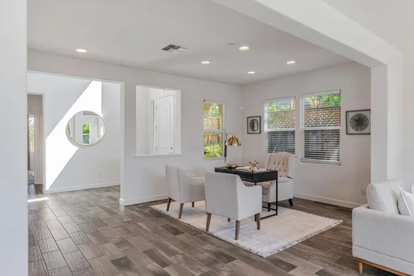 a view of hallway with windows and furniture
