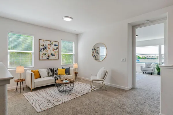 a bedroom with a bed and large windows