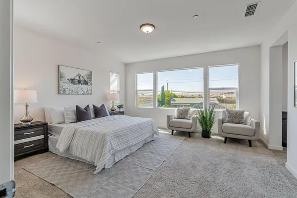 a bed room with a bed and a large window