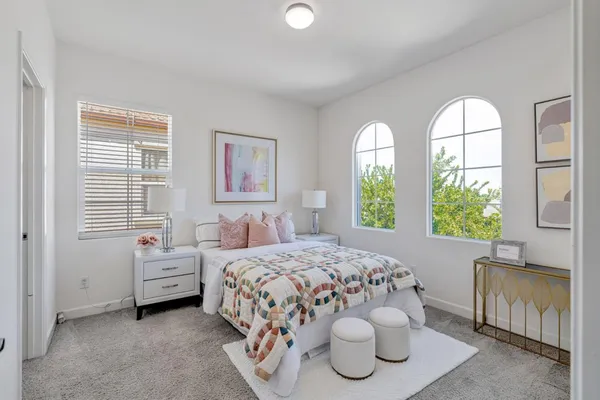 a bedroom with a bed and a window