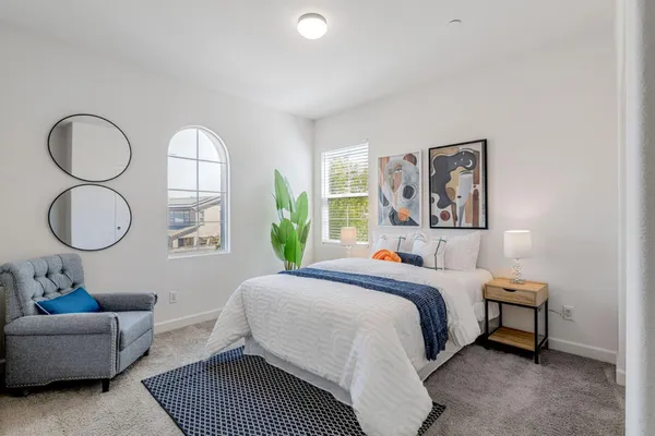 a bedroom with a bed and a couch