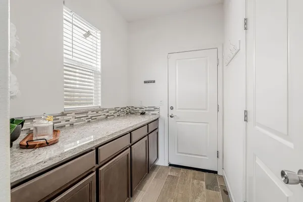 a bathroom with a granite countertop sink a toilet and bathtub