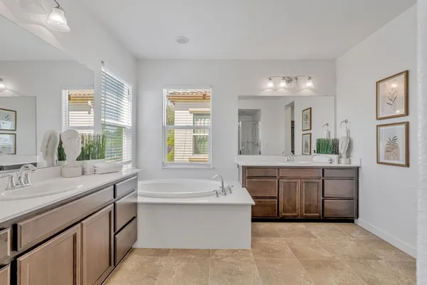 a spacious bathroom with a shower sink and mirror