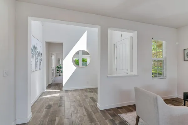 a living room with furniture and large windows