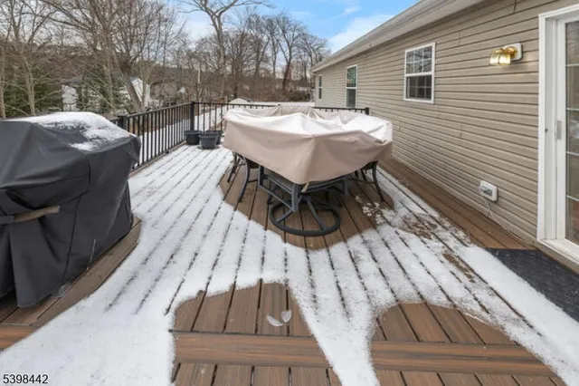 a view of a roof deck with wooden floor and fence
