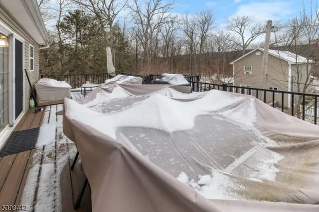 a view of backyard with table and chairs and wooden fence