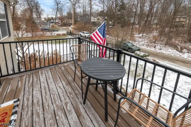 a view of balcony with wooden floor and outdoor seating