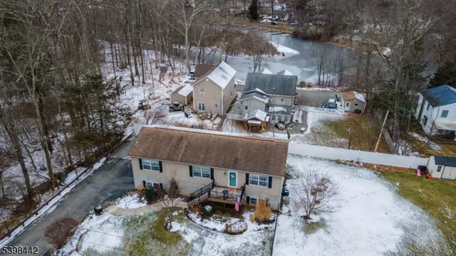 an aerial view of a house with garden space and sitting area