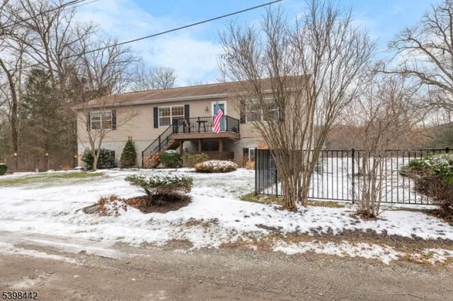 a view of a house with a snow in the yard
