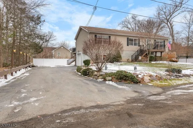 a view of a house with a yard covered in snow