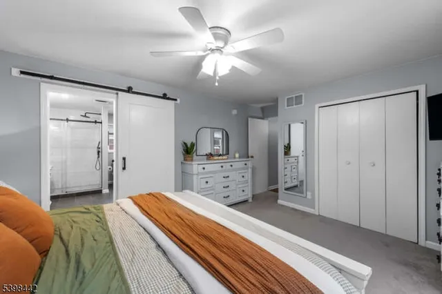 a spacious bedroom with a bed and a chandelier