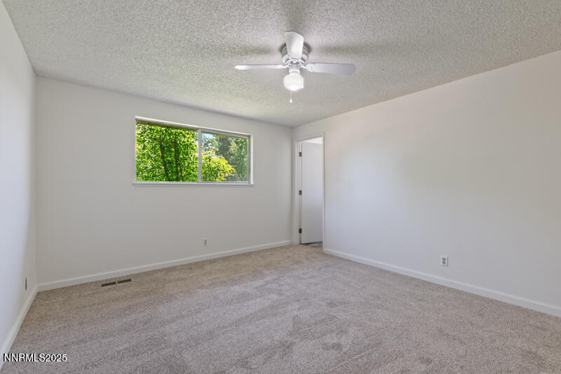 2995 Santa Ana Drive Reno, NV 89502 - Photo 11 of 19 an empty room with windows and fan