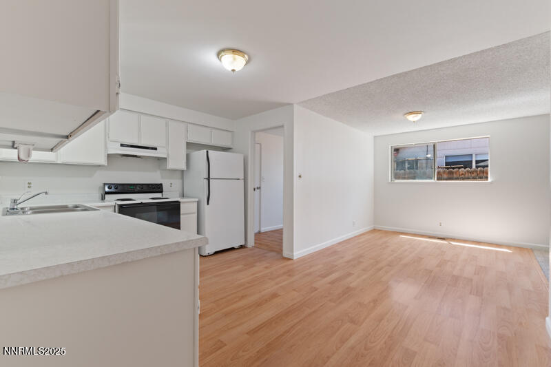 2995 Santa Ana Drive Reno, NV 89502 - Photo 4 of 19 a bedroom with a bed and a view of kitchen