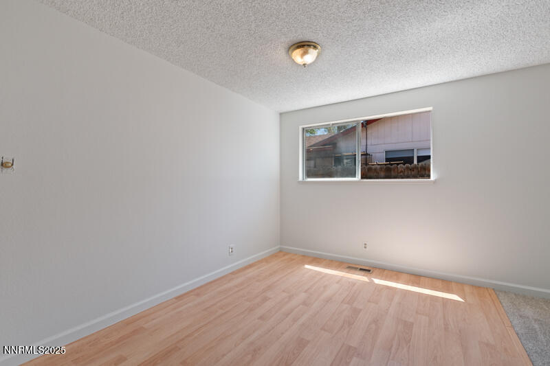 2995 Santa Ana Drive Reno, NV 89502 - Photo 7 of 19 wooden floor in an empty room with a window