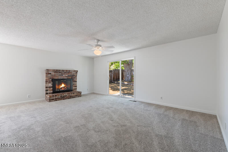 2995 Santa Ana Drive Reno, NV 89502 - Photo 9 of 19 an empty room with a fireplace and window