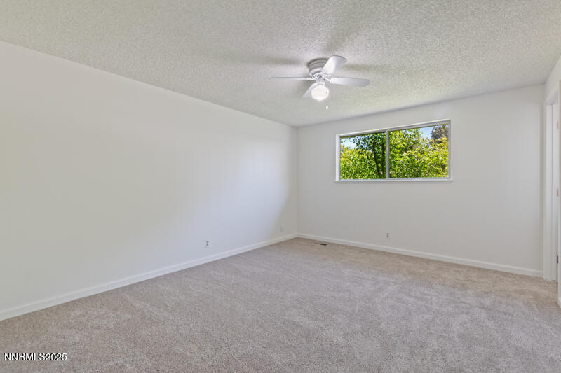 2995 Santa Ana Drive Reno, NV 89502 - Photo 10 of 19 an empty room with windows and fan
