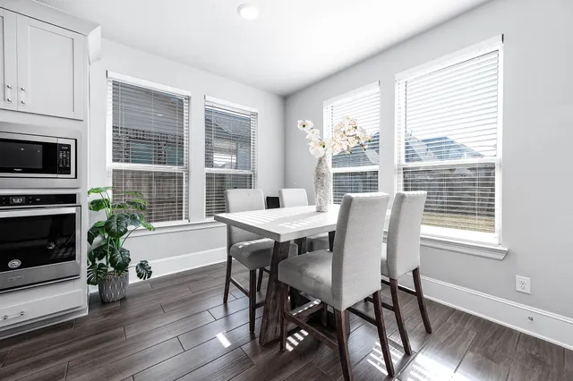 a view of a dining room with furniture window and wooden floor