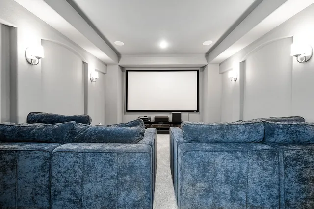 a living room with couches couches and a flat screen with a flat screen tv