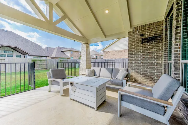a outdoor living space with patio furniture and garden view