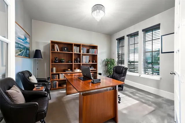 a living room with furniture a flat screen tv and a floor to ceiling window