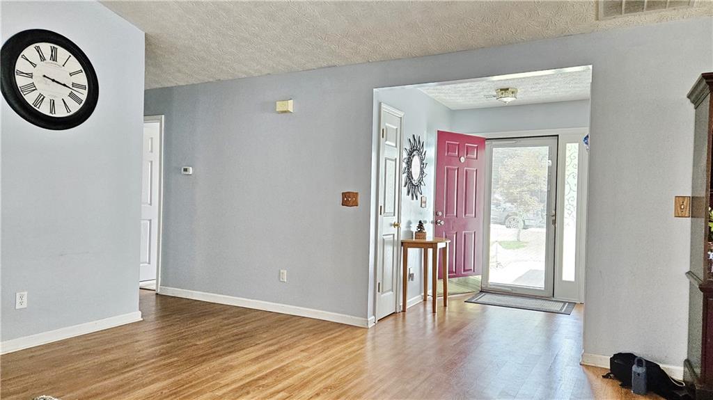 2233 Hansford Pass Buford, GA 30519 - Photo 16 of 45 a view of a hallway with wooden floor