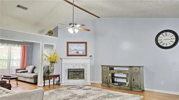 a living room with furniture a chandelier and a fireplace